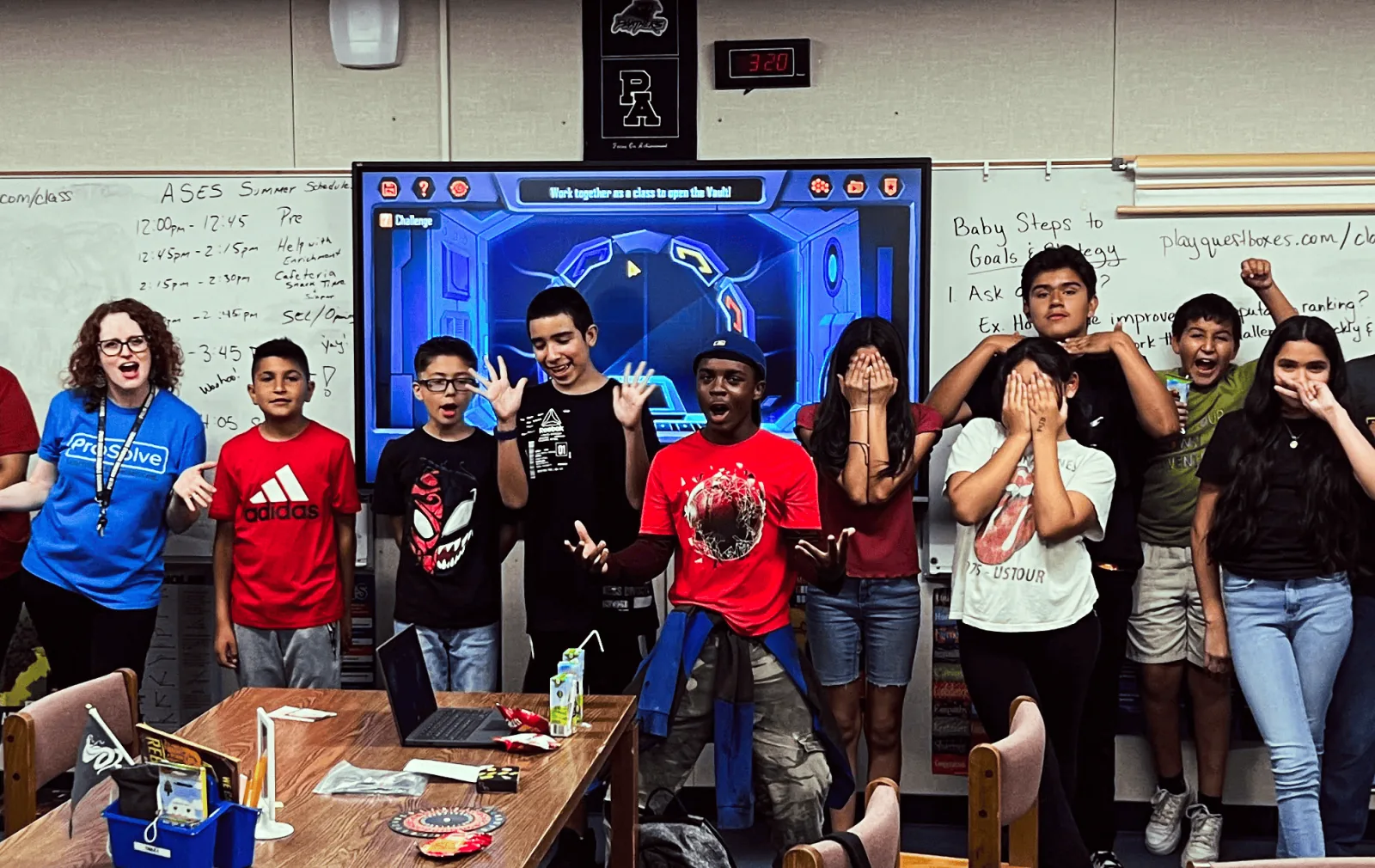 Students reacting with excitement to a challenge on the classroom screen